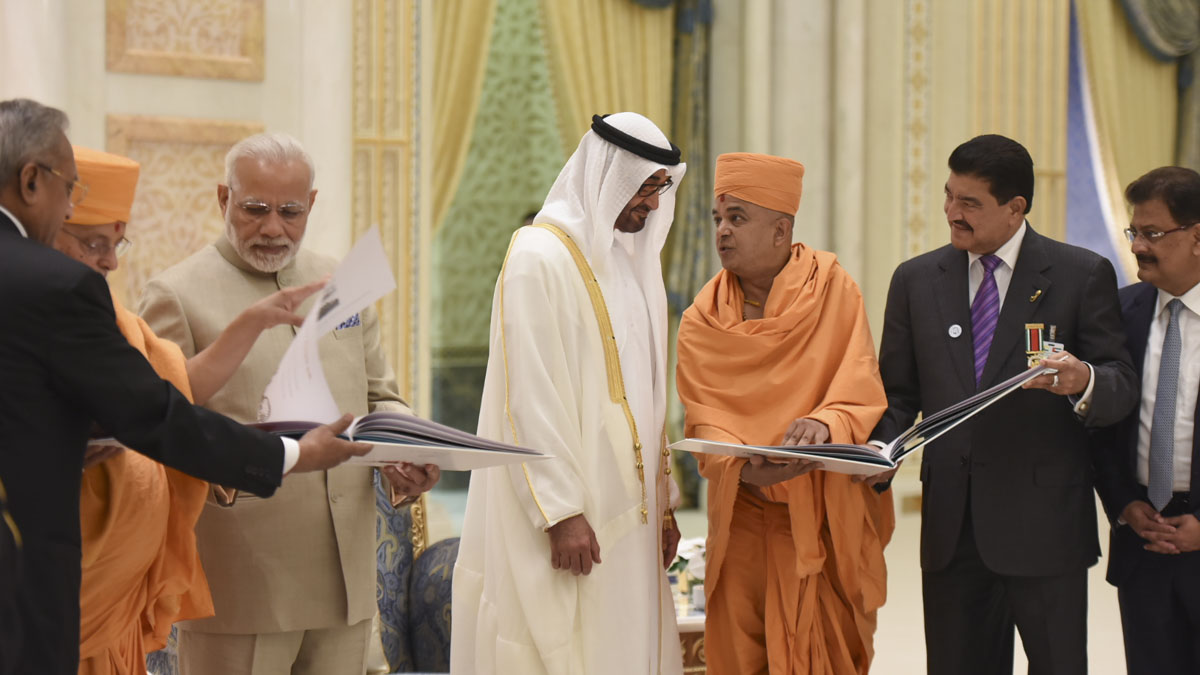 Crown Prince HH Mohamed bin Zayed al Nahyan and PM Narendra Modi are shown a book outlining the temple project