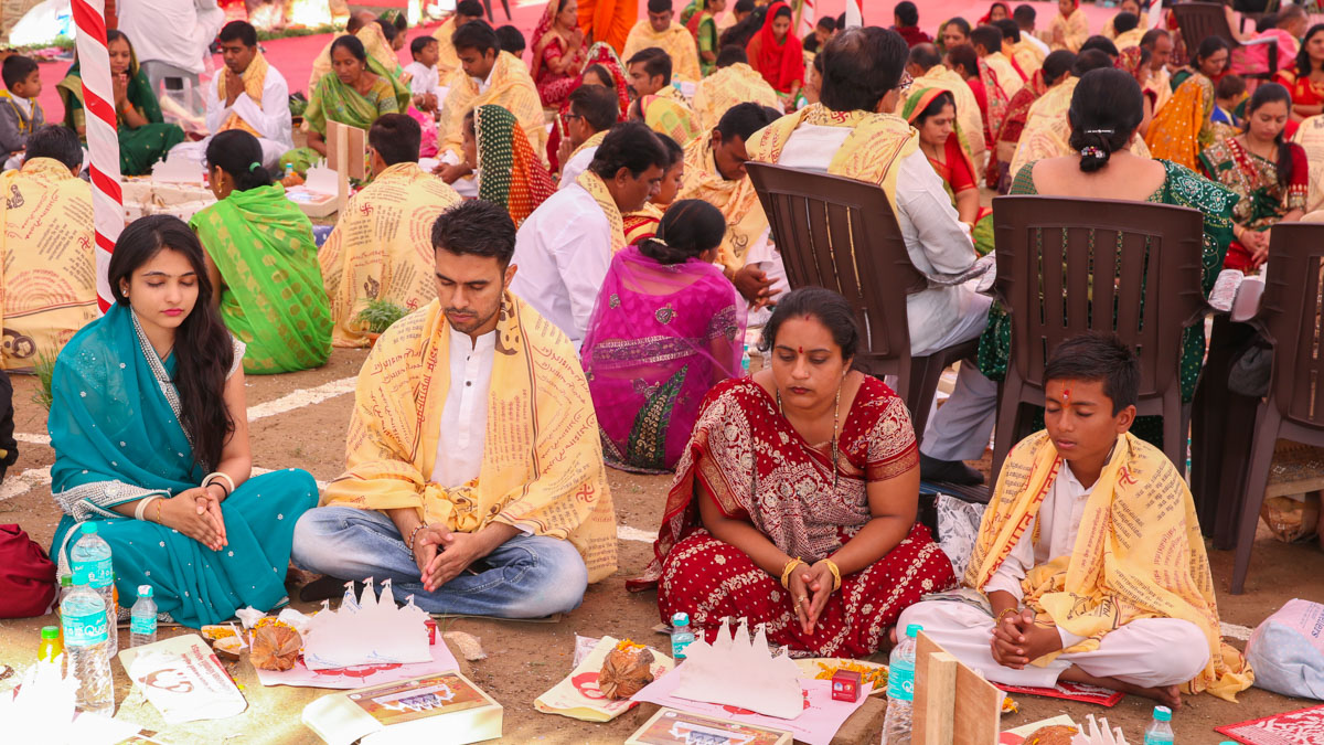 Devotees participate in yagna rituals