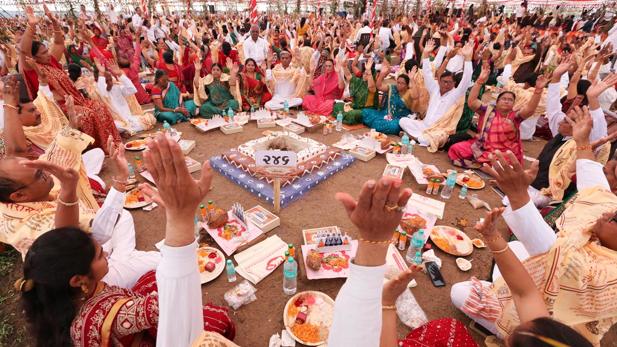 Devotees participate in yagna rituals