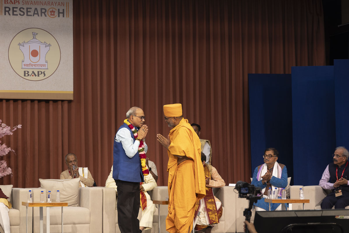 Dharmatilak Swami honors Dr. K. Srinivas Rao, Secretary, National Literature Academy, Delhi, with a garland